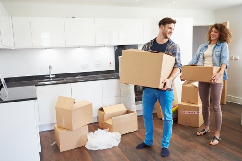 Professional movers handling boxes and furniture in East London