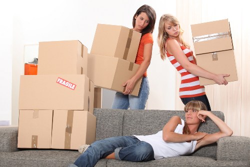 Professional movers preparing furniture for a residential relocation in Canary Wharf